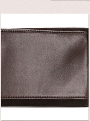 Close-up of a dark brown leather wallet or clutch showing the smooth texture and stitched edges.